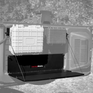 Grayscale-style view of the Ford Bronco Tailgate Table deployed as a workspace with two storage cases attached to the tailgate system.