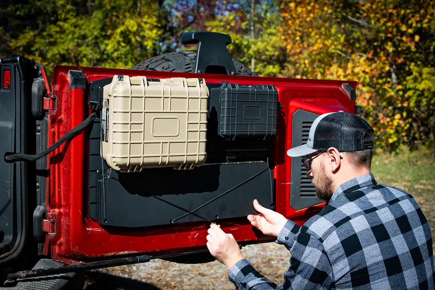 Ford Bronco Tailgate Table A person tucking the Ford Bronco Tailgate Table away in seconds, demonstrating the convenient foldable design for quick trail transitions.