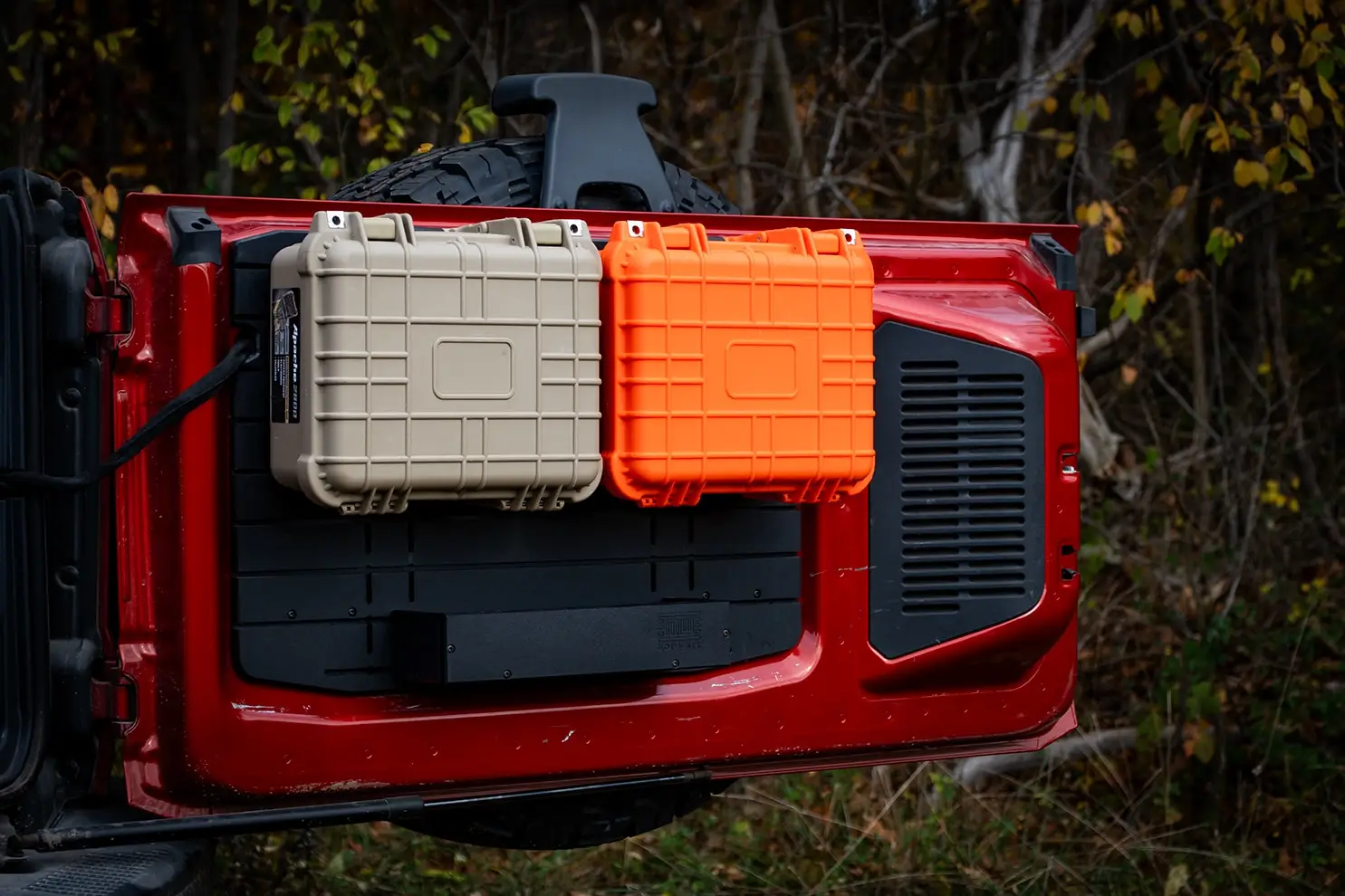 Ford Bronco Tailgate Storage Package The Ford Bronco Tailgate Storage Shelf Package in action, showing a tan and an orange modular case mounted above a large utility shelf for trail gear organization.
