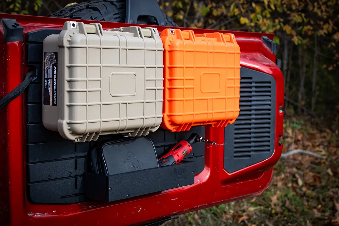 Ford Bronco Tailgate Storage Package A red power tool and accessory pouch organized within the ModWall Large Shelf on a Ford Bronco Tailgate Panel, demonstrating customizable utility for off-road essentials.